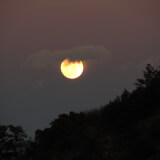 Moon peeking through a cloudy night