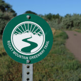 Trail signs that reads Rocky Mountain Greenway Trail