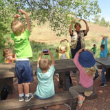 Young children playing and learning in the outdoors.