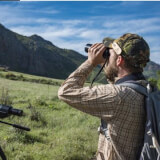 Man looking through binoculars. 